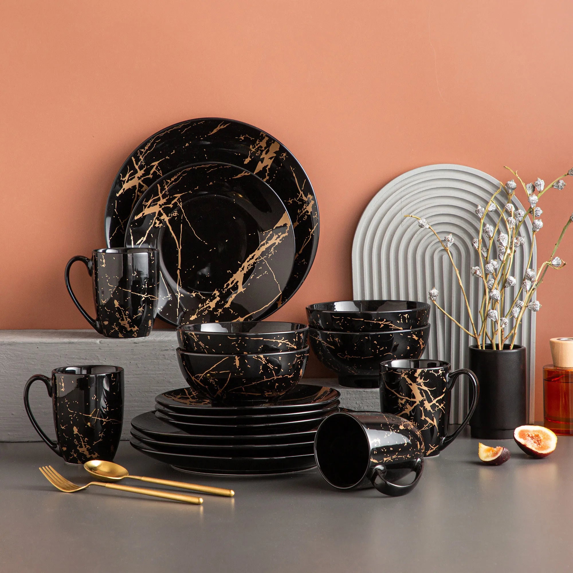 Elegant black dinnerware set with gold splatter design, modern luxury tableware for formal dining and special occasions